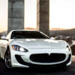 white-coupe-sport-car-standing-road-front-view-min